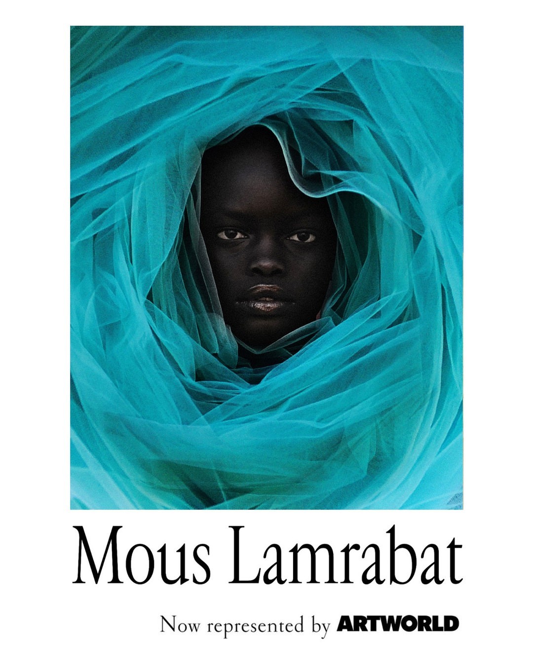 Portrait of a dark-skinned woman enveloped in a flowing, semi-transparent, bright turquoise fabric, set against a clean white backdrop.