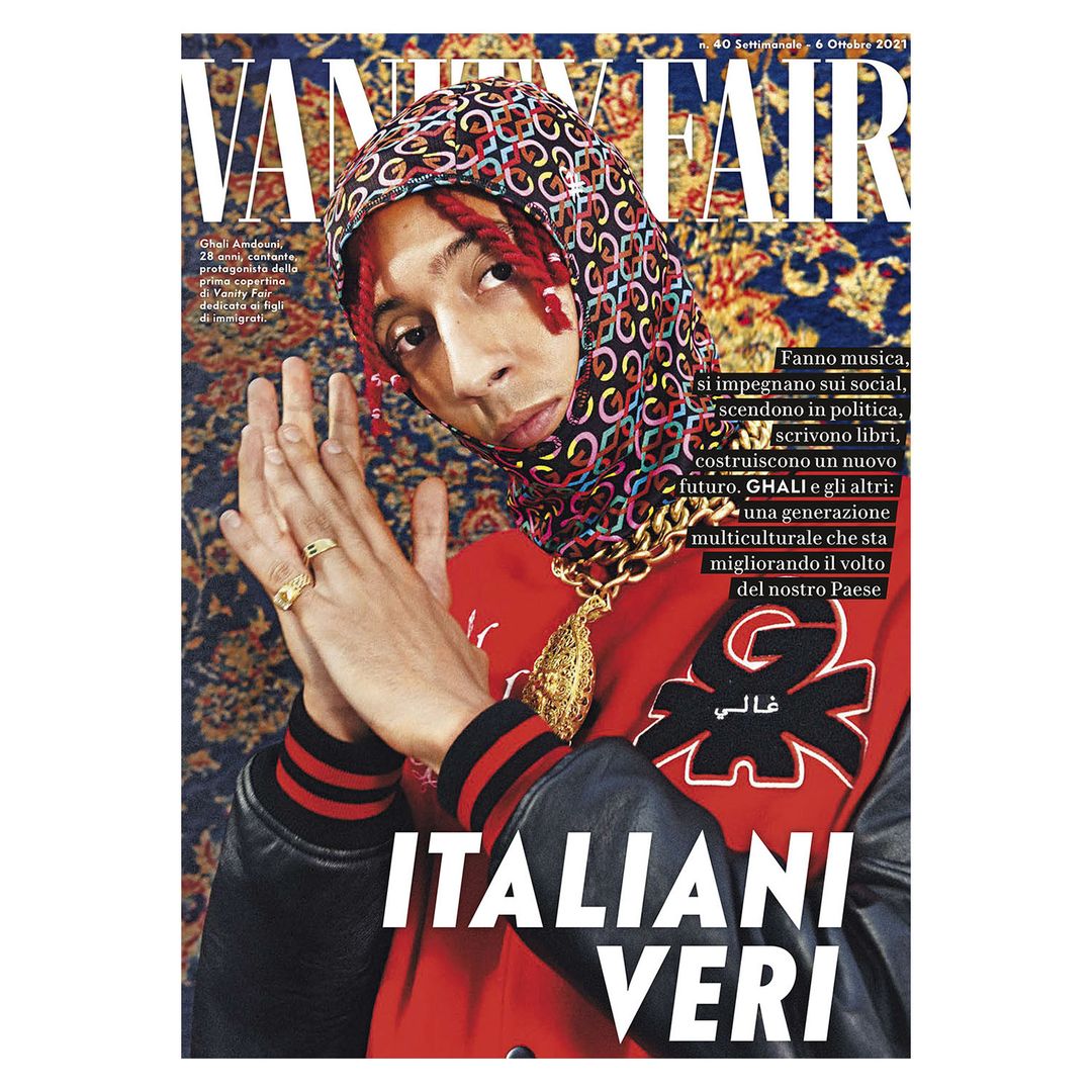 Vanity Fair cover featuring a person with a patterned head covering, gold jewelry, and a red jacket, set against a patterned backdrop.