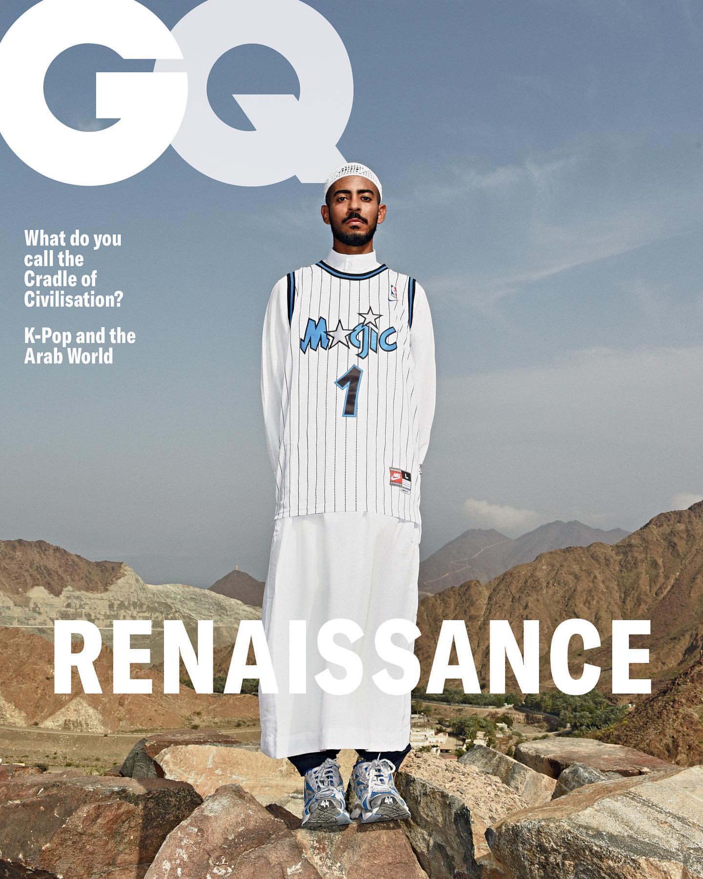 Magazine cover featuring a man in athletic wear, standing atop rocks with a mountain range backdrop, under the GQ logo and magazine text.