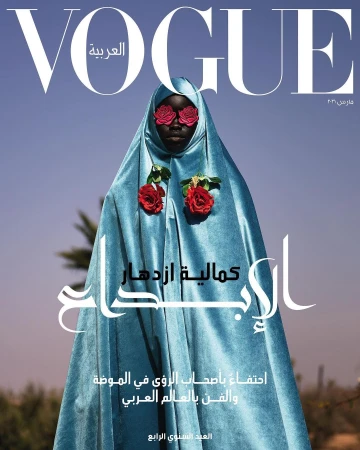 Vogue Arabia cover featuring a Black woman in a light blue robe adorned with red roses, set against a clear blue sky backdrop.