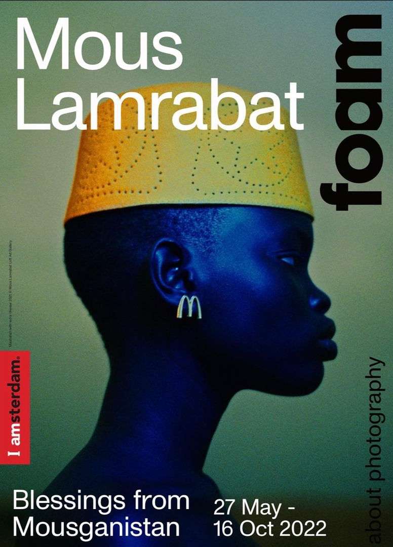 Profile portrait of an individual with dark skin wearing a yellow hat and earring, against an olive-green backdrop with white text.