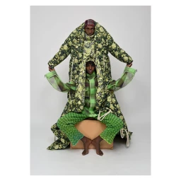 Two Black models stacked in green floral and plaid patterned outerwear against a plain white studio background by Mous Lamrabat.