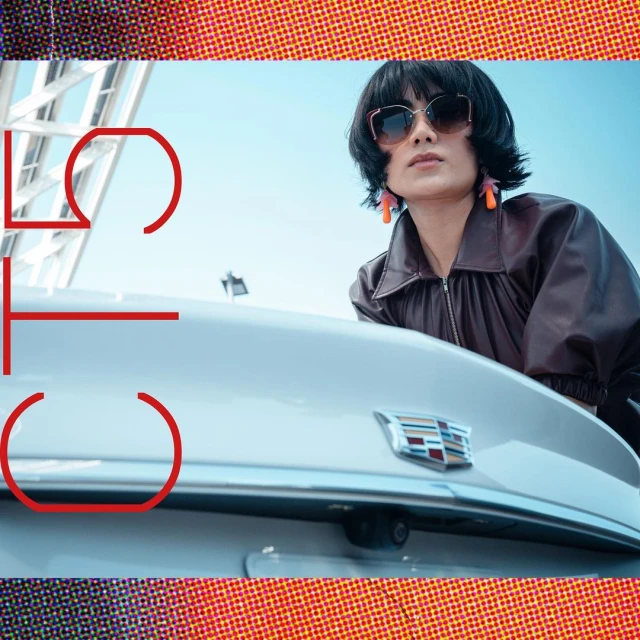A woman in sunglasses leans on a white car with a modern art-inspired graphic overlaying the scene. The sky is visible in the background.