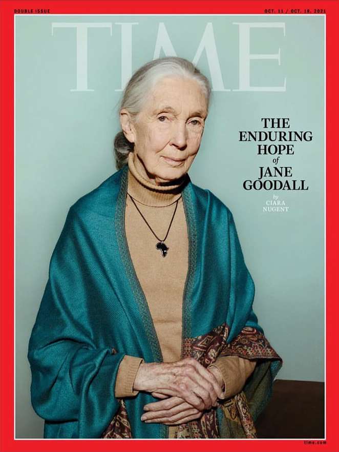 Time Magazine cover featuring Jane Goodall in a medium shot, wearing a tan turtleneck, blue wrap, and necklace with an Africa pendant.