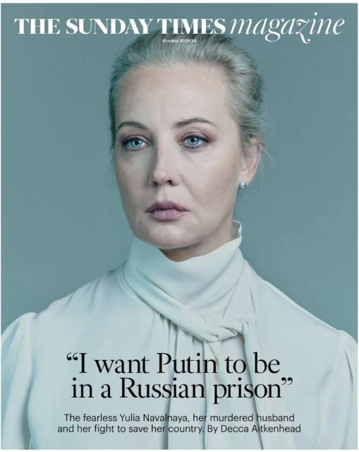 Magazine cover portrait of Yulia Navalnaya looking forward with a grey background, wearing a white blouse and pearl earrings.