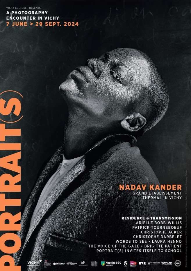 Black and white portrait of a man with a shaved head looking upward on a poster for a photography encounter in Vichy, France.