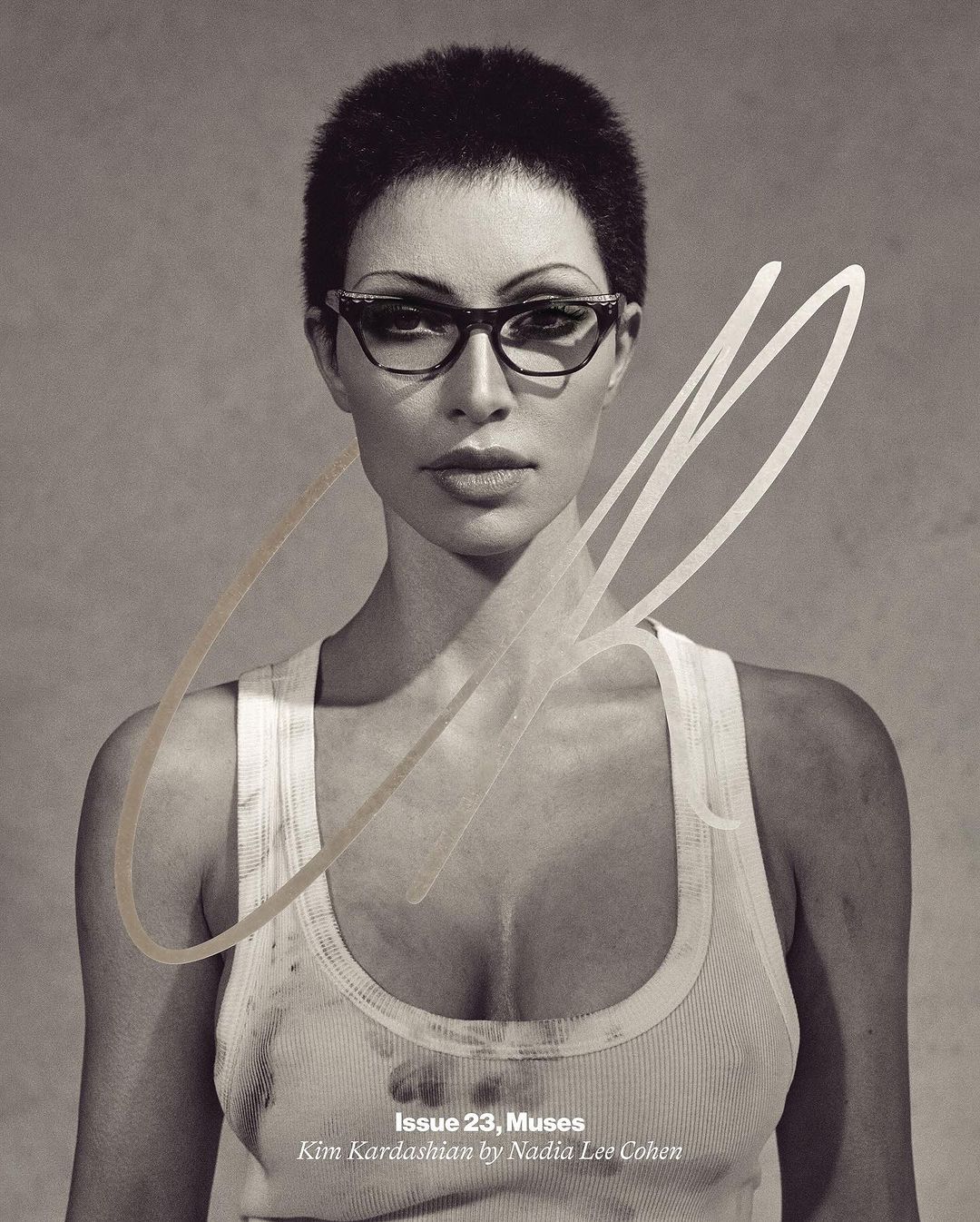 Black and white portrait of an adult woman wearing eyeglasses and a white tank top, with dark hair and light skin against a neutral background.