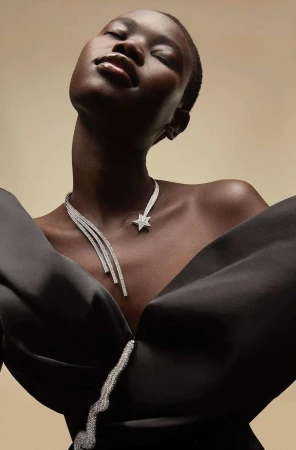 Close-up portrait of a Black woman wearing a diamond star necklace and black dress by photographer Nadia Ryder