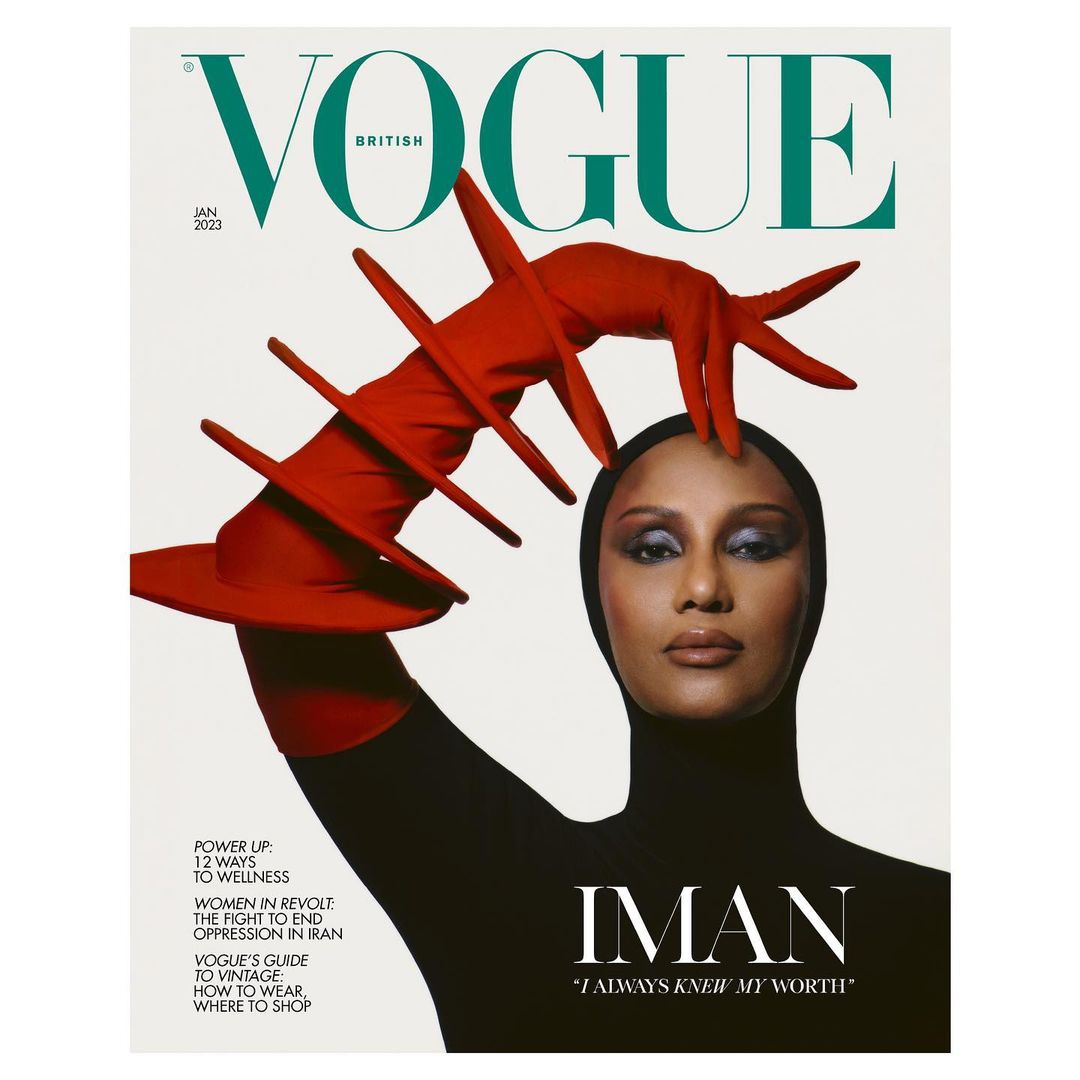 British Vogue cover featuring Iman in a black bodysuit and red avant-garde glove, against a clean white backdrop, January 2023 issue.