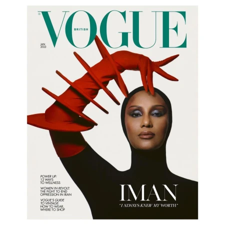 British Vogue cover featuring Iman in a black bodysuit and red avant-garde glove, against a clean white backdrop, January 2023 issue.