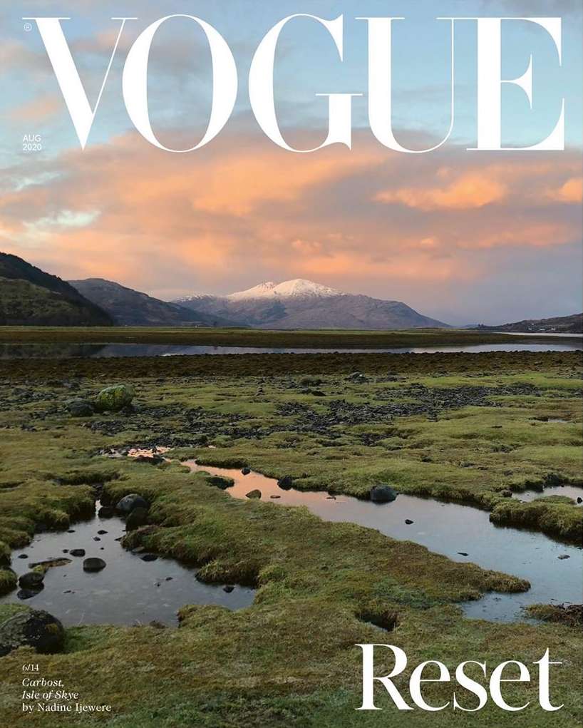 Vogue magazine cover featuring a scenic landscape with a marshy field, mountains, and cloudy sky in muted, natural tones.
