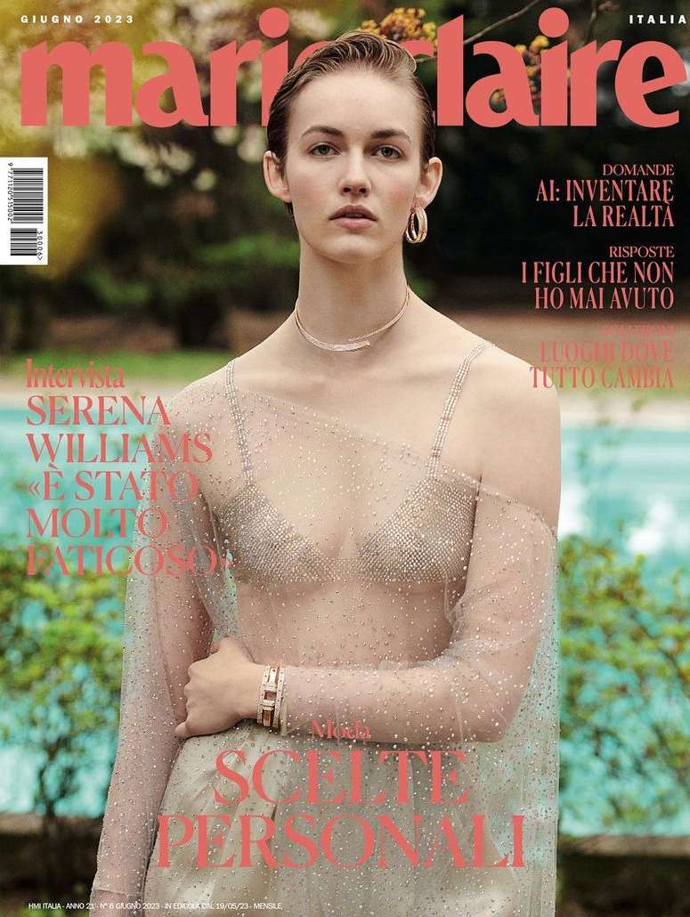 Marie Claire Italia cover featuring a woman wearing a sheer top in a garden setting with a swimming pool, showcasing fashion and beauty.