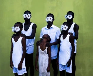 Group of six black males wearing white tank tops and shirts with white daisy flowers covering their eyes against a vibrant green wall.