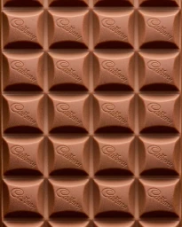 Macro shot of milk chocolate bar surface showing embossed brand logo across squared chunks