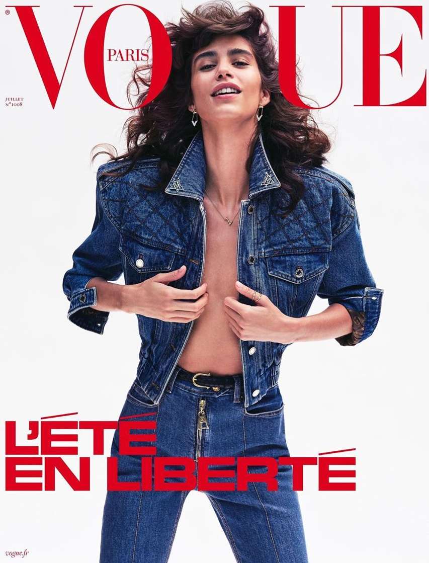 Vogue Paris cover featuring a woman in a denim jacket and jeans against a white background, showcasing a blend of fashion and simplicity.
