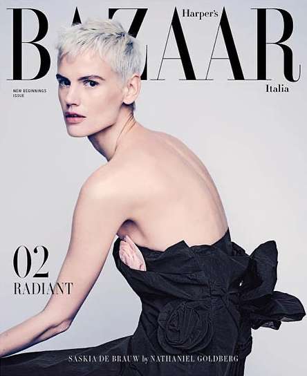 Fashion magazine cover featuring Saskia de Brauw with platinum blonde hair and backless dress against a neutral backdrop.