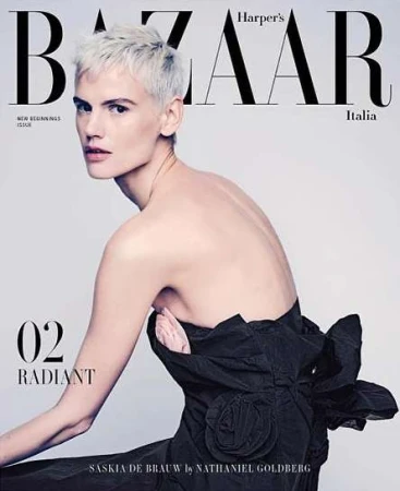 Fashion magazine cover featuring Saskia de Brauw with platinum blonde hair and backless dress against a neutral backdrop.
