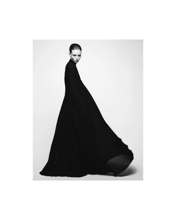 Model in a long black flowing dress against a white studio background captured by Nathaniel Goldberg in Paris.