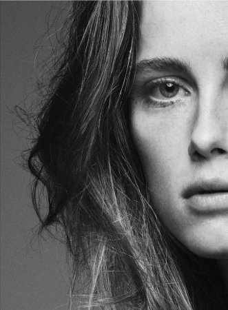 Close-up black and white portrait of a woman's face and hair by photographer Nathaniel Goldberg.
