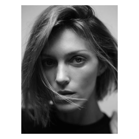Close-up portrait of a woman with short dark hair in soft monochromatic light captured by Nathaniel Goldberg in Paris.