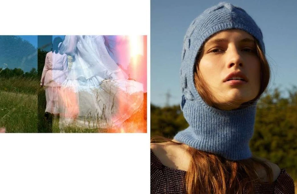 Woman wearing blue knit balaclava and dress in outdoor portrait with filtered landscape and neutral tones on an overcast day.