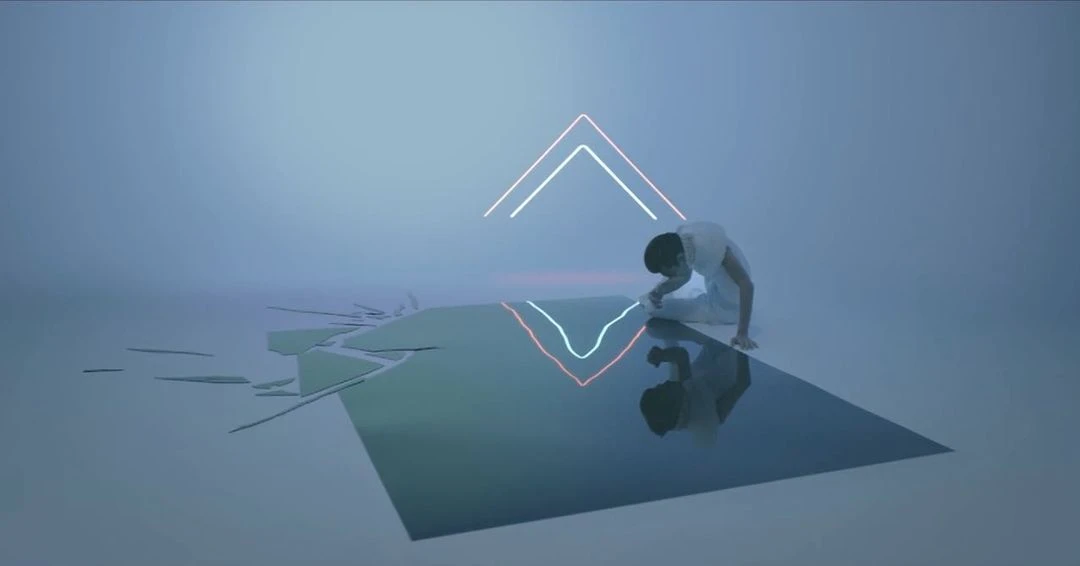 A slender adult in white reaches toward a reflective surface under neon lights against a stark white studio background.