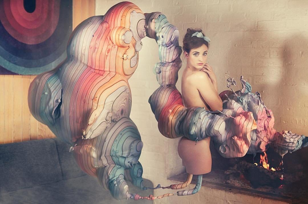 Artistic shot featuring a female model with bare shoulders posing near unique art installation with warm lighting and pastel color palette.