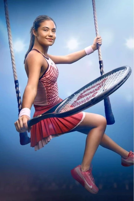 A tennis player is sitting on a swing holding a racket and wearing tennis apparel in front of a blue background with lights.