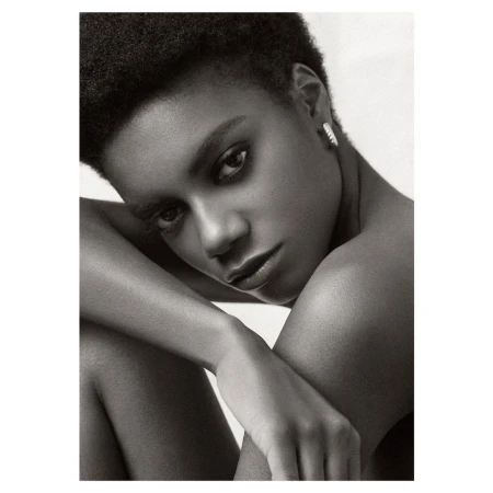 Close-up monochrome portrait of a Black woman with short dark hair and a serious expression by photographer Nick Eucker.