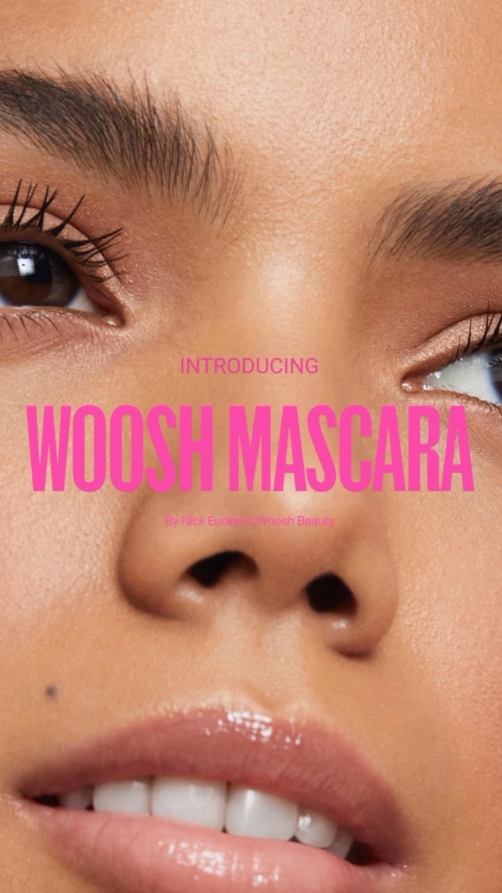 Close-up of a woman's face with focus on her eyes and lips, featuring pink text overlay advertising Woosh Mascara, promoting a beauty product.