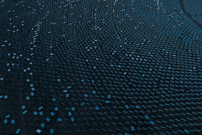 Aerial view of a large-scale solar power plant with neatly arranged dark photovoltaic panels against a dark terrain, generating clean energy.