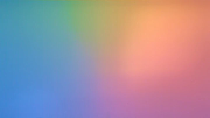 Abstract gradient background with blending hues of blue, purple, green, orange, and pink creating a soft, blurred pastel aesthetic.