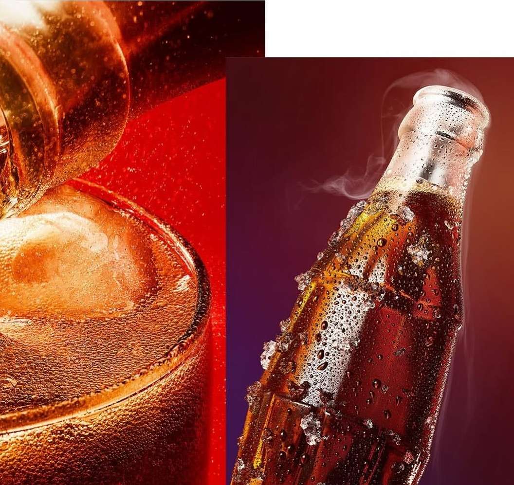 Close-up of a glass of soda with ice and condensation, and a vintage soda bottle with water droplets and vapor, on a dark backdrop.