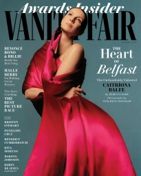 Magazine cover featuring actress Caitríona Balfe wearing a voluminous crimson and magenta gown with matching pink gloves against a blue background