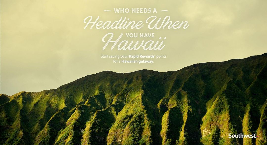 Lush green mountainside under a pale yellow sky with promotional travel text for Southwest Airlines and Rapid Rewards points.