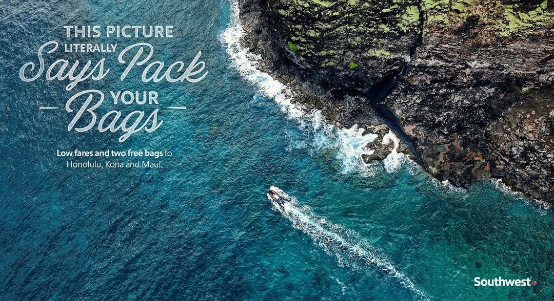 Aerial view of deep blue ocean water near a rocky volcanic shoreline, a small boat in the water, text overlay and brand logo.