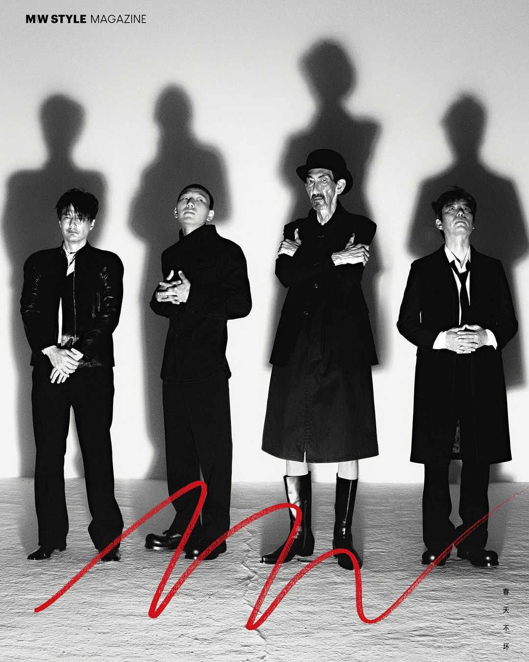 Black and white portrait of four Asian adult men standing indoors with shadows and a red squiggle in front of them.