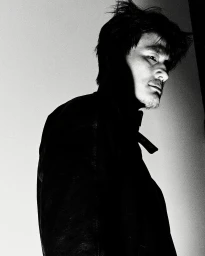 Monochrome portrait of an Asian man with dark hair in profile against a light background by Nick Yang