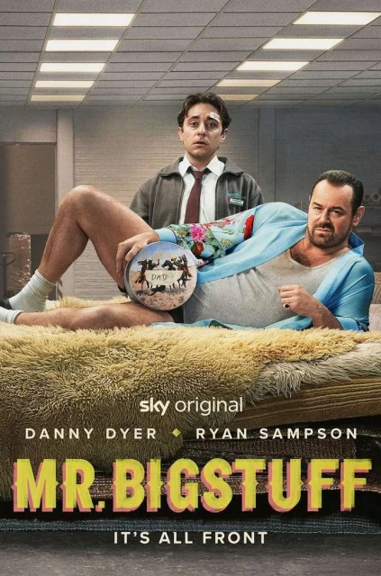 Promotional image for 'Mr. Bigstuff' features Danny Dyer reclining on a furry bed, holding a round object, with Ryan Sampson standing behind.