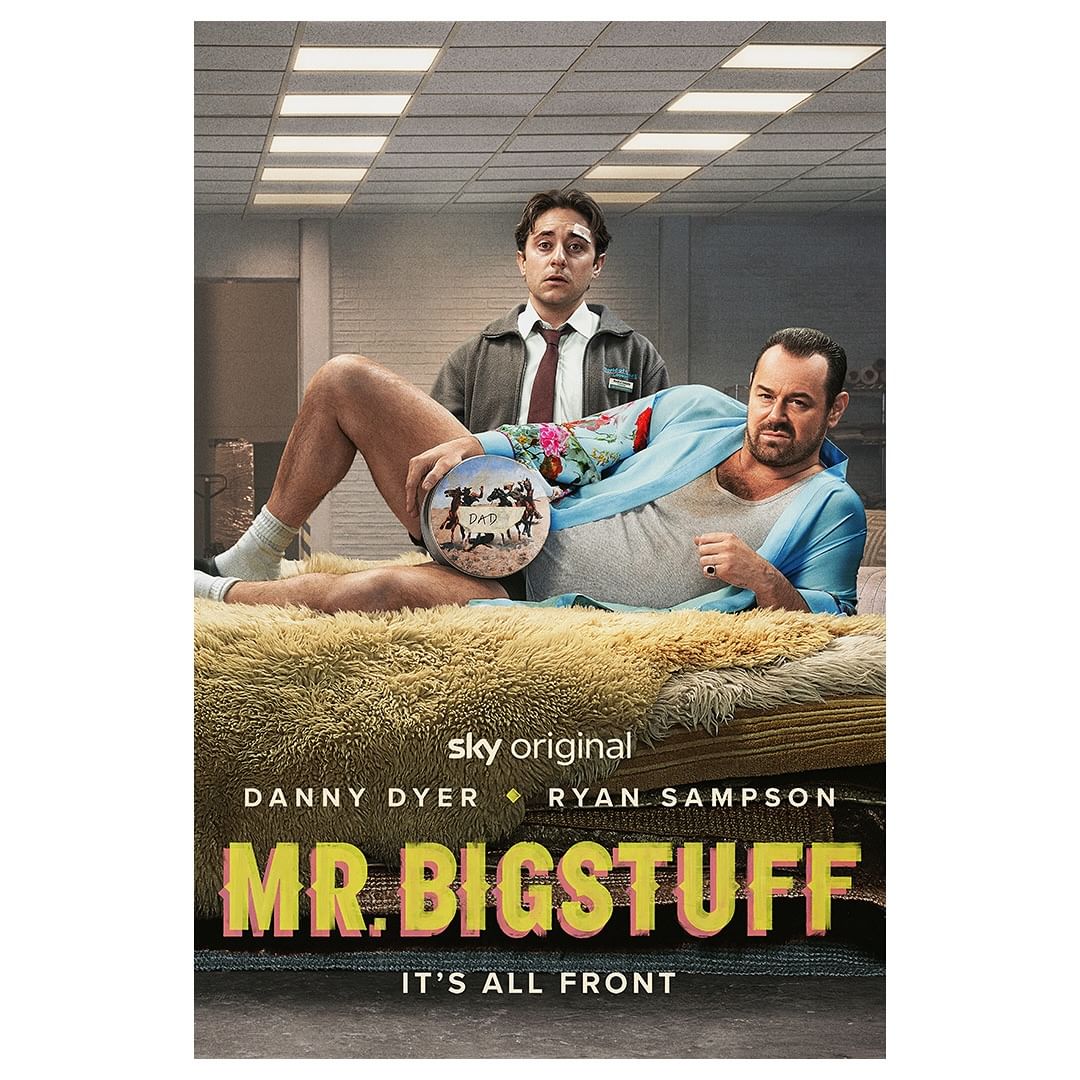 Promotional poster for 'Mr. Bigstuff' featuring two men indoors. One is reclining, and the other stands behind him in the scene.