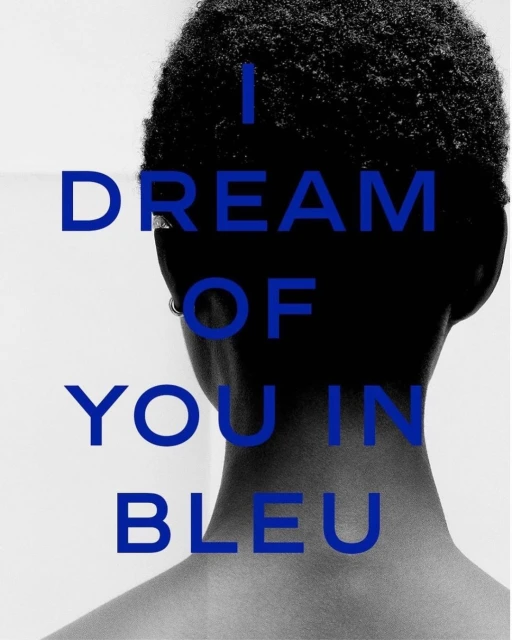 Monochromatic studio portrait of an African-descent adult female from the back, with blue 'I DREAM OF YOU IN BLEU' text overlay.