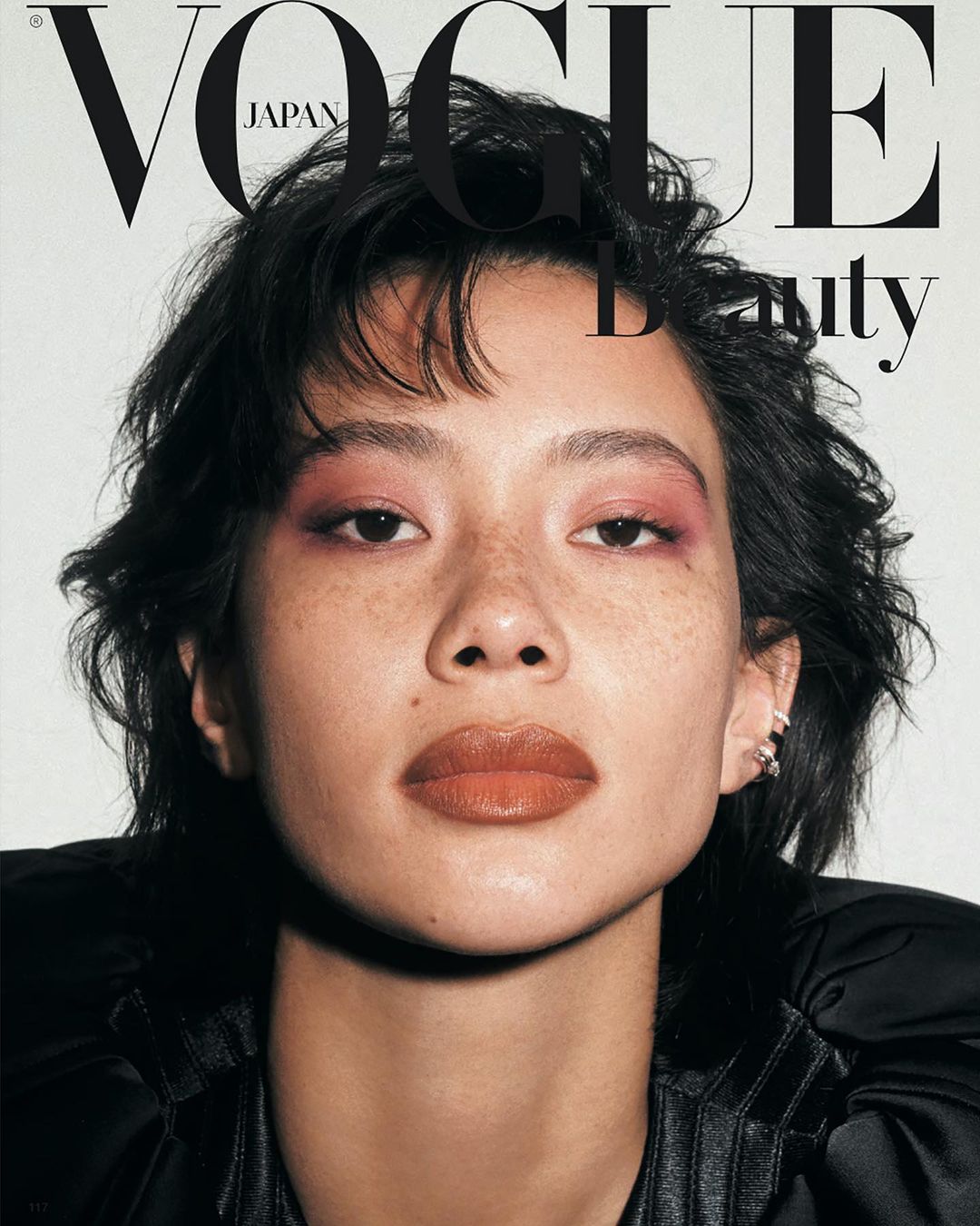 Vogue Japan Beauty cover featuring an Asian woman with short dark hair, pink eyeshadow, and brown lipstick in a close-up shot.