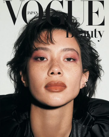 Vogue Japan Beauty cover featuring an Asian woman with short dark hair, pink eyeshadow, and brown lipstick in a close-up shot.