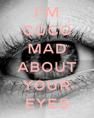 Close-up of a human eye with long eyelashes, featuring overlaid pink text 'I'm Coco mad about your eyes' on a black and white background.