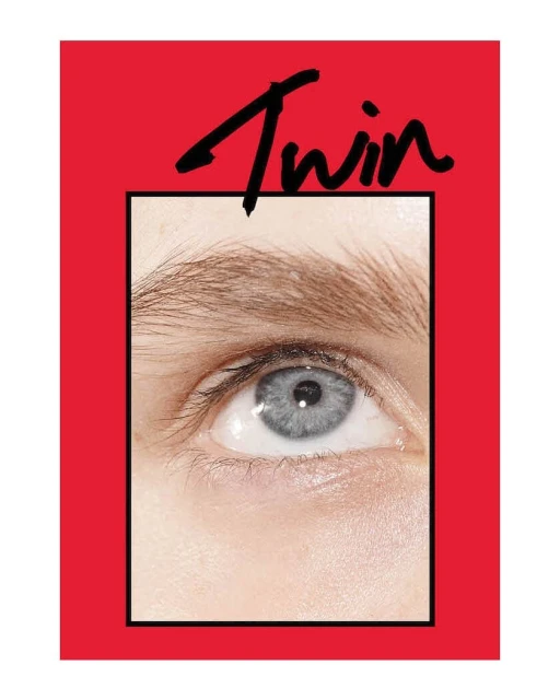 Close-up shot showcases the eye and eyebrow of an adult female, framed within a bold red border, highlighting beauty and editorial style.