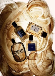 Four perfume bottles arranged on a dynamic painted background featuring bold brown and cream brushstrokes by Nicolas Kowalski