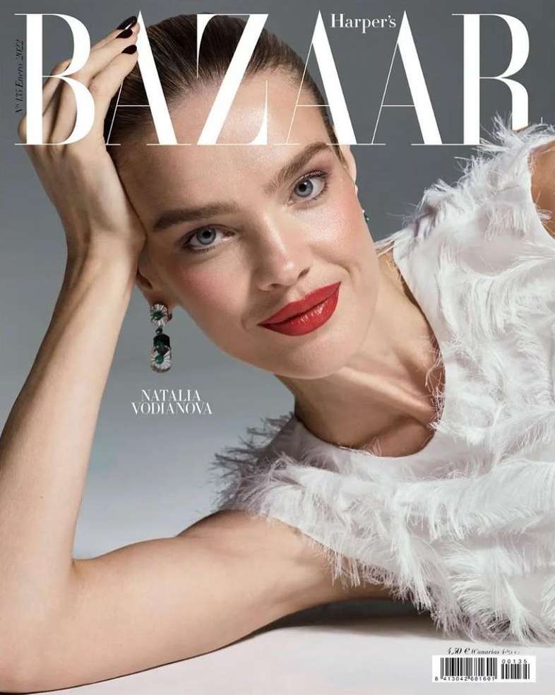 Natalia Vodianova gazes at the camera on a Harper's Bazaar magazine cover, adorned with Bazaar masthead and a white feathered top.
