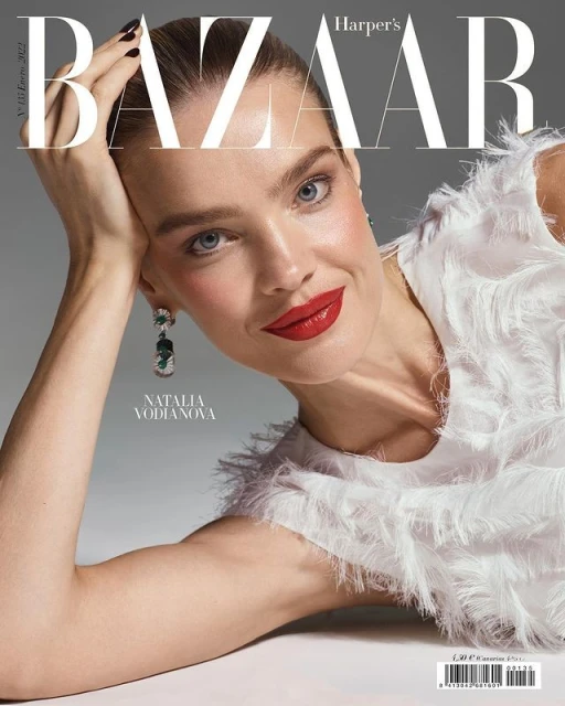 Natalia Vodianova on Harper's Bazaar cover featuring close-up of the model with red lips, white feathered top, and statement earrings.