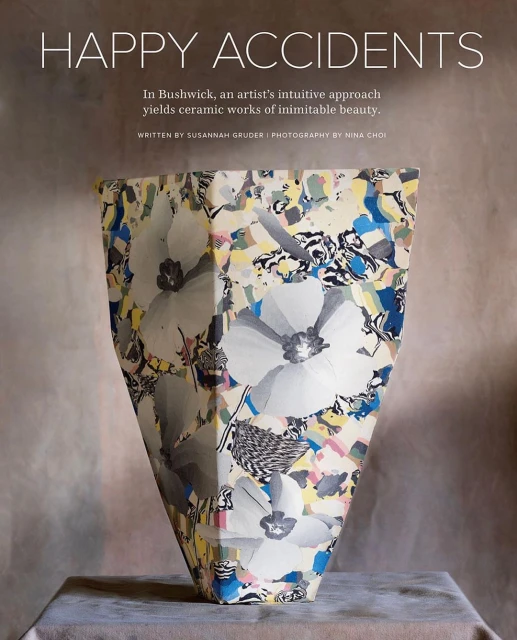 Floral ceramic vessel on a table, featuring a unique flower pattern and a modern, geometric design, blending art and functionality.