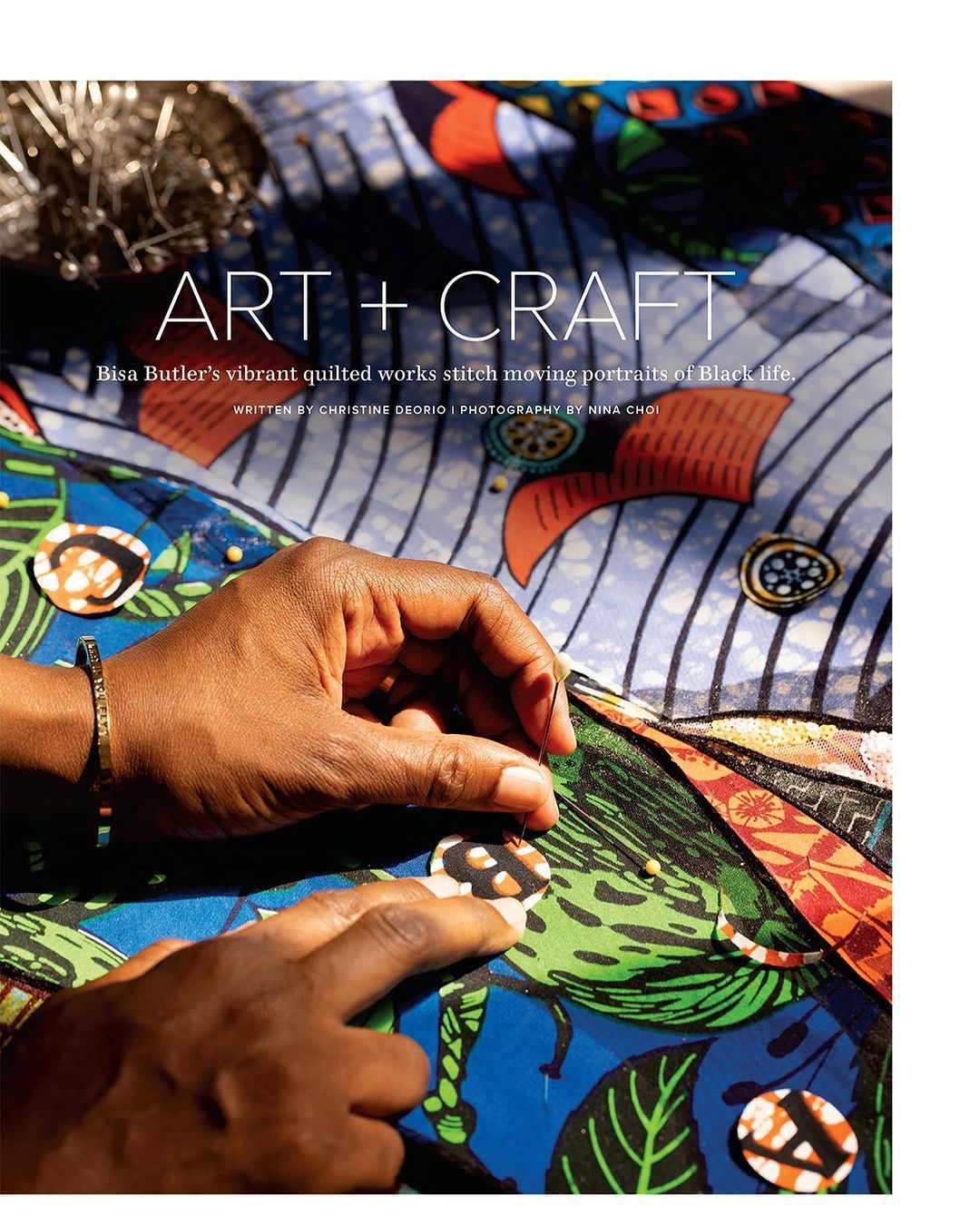 Close-up of hands sewing colorful patterned fabric with needle. Art and craft project featuring detail of stitching and textile work.